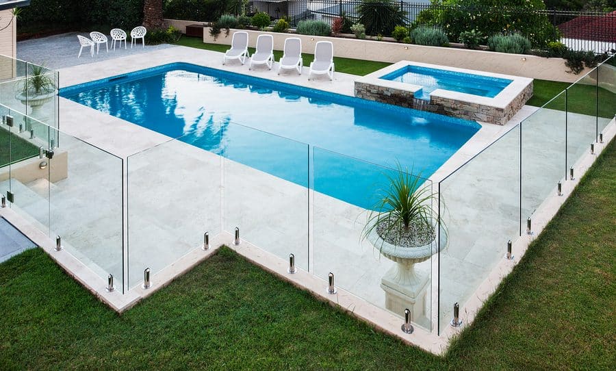 Modern Swimming Pool Covered With Glass Panels Beside A Lawn Modern Swimming Pool Covered With Glass Panels Beside A Lawn